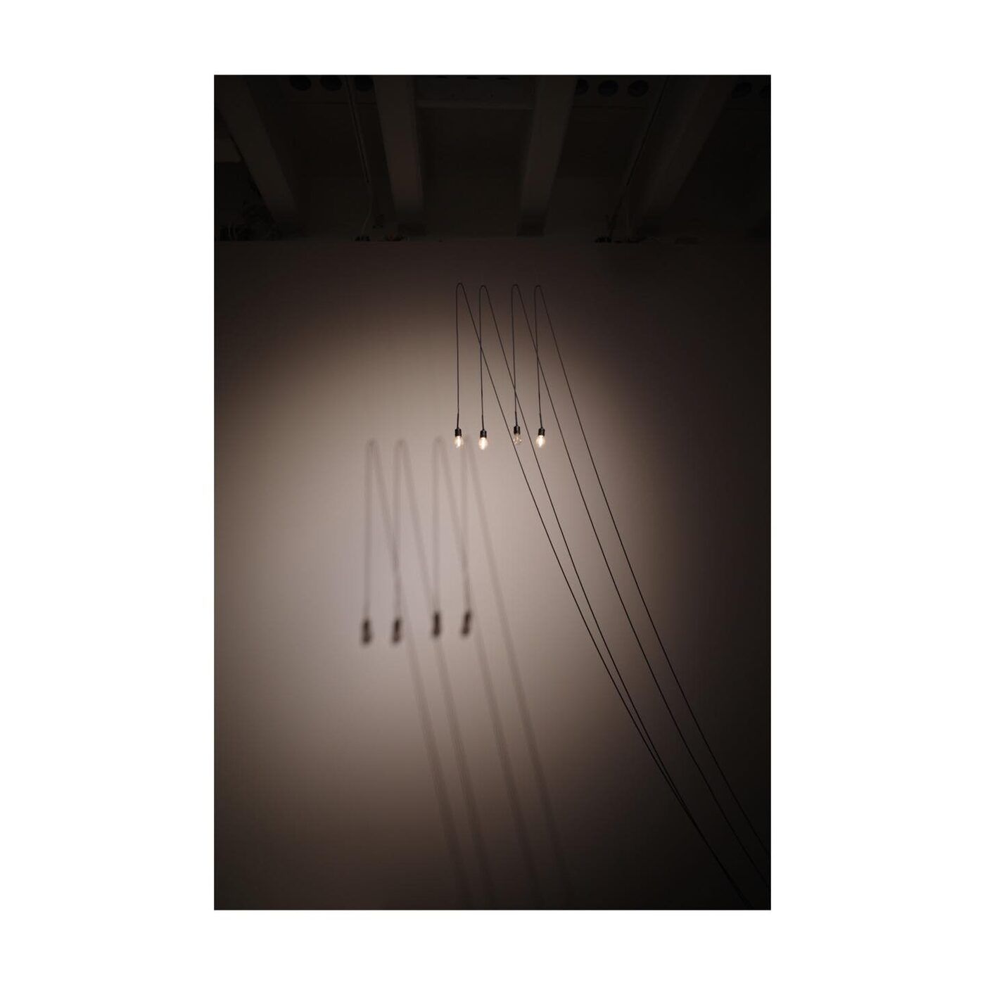 Fishing lines hanging in dark abstract composition