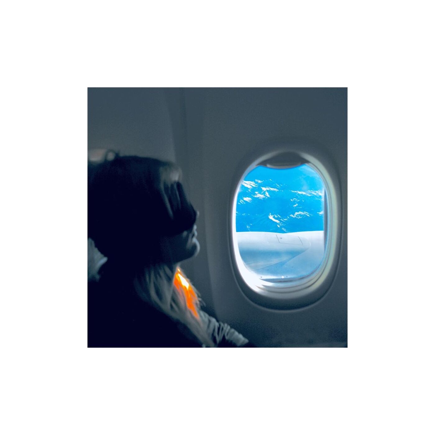 Looking out an airplane window at clouds