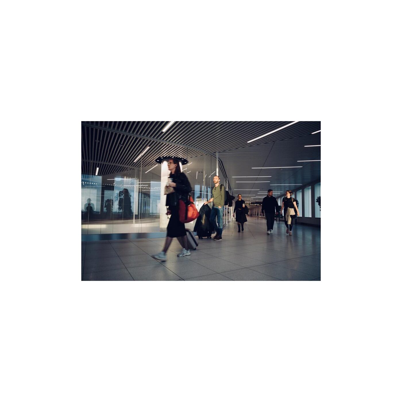 Motion blur of travelers rushing through an airport