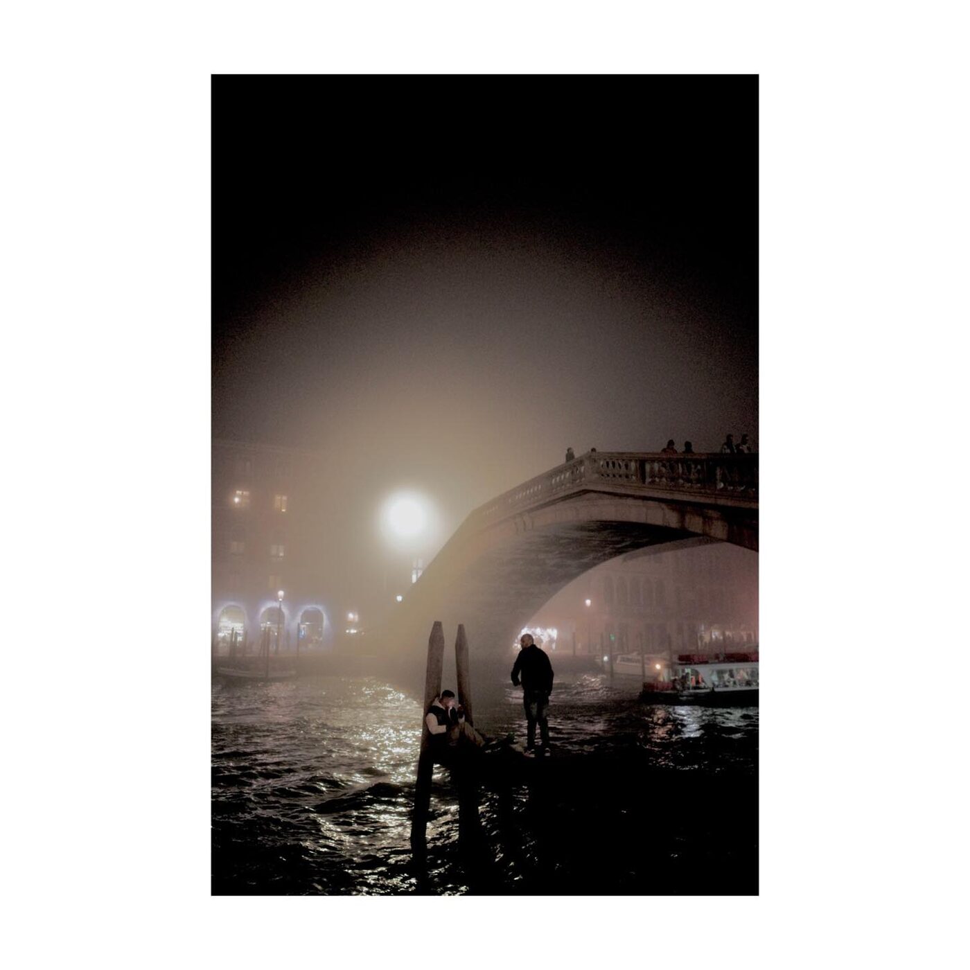 A canal disappearing into thick fog