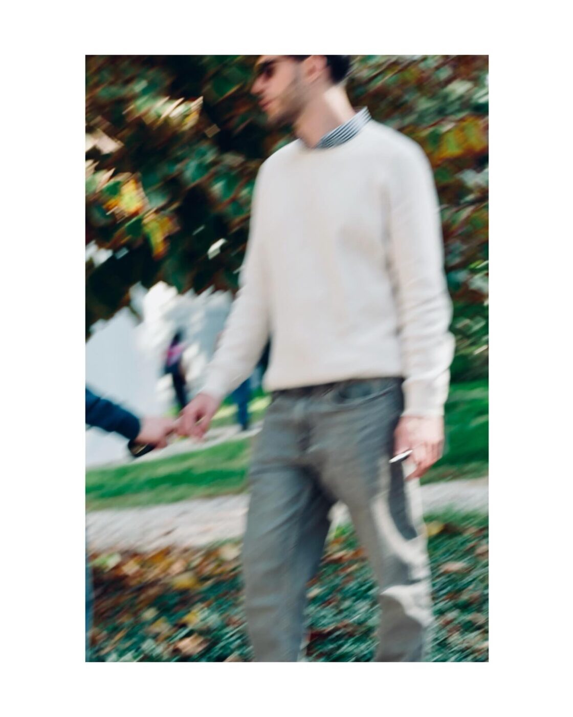 A person walking through an autumn park