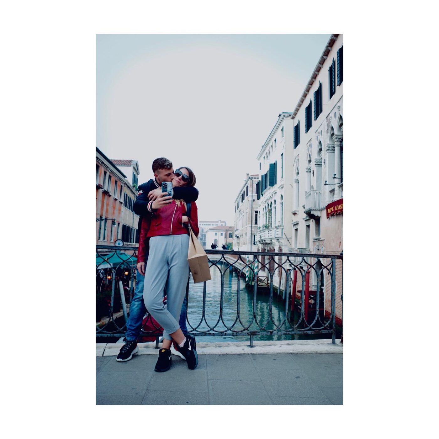 A couple embracing on a bridge
