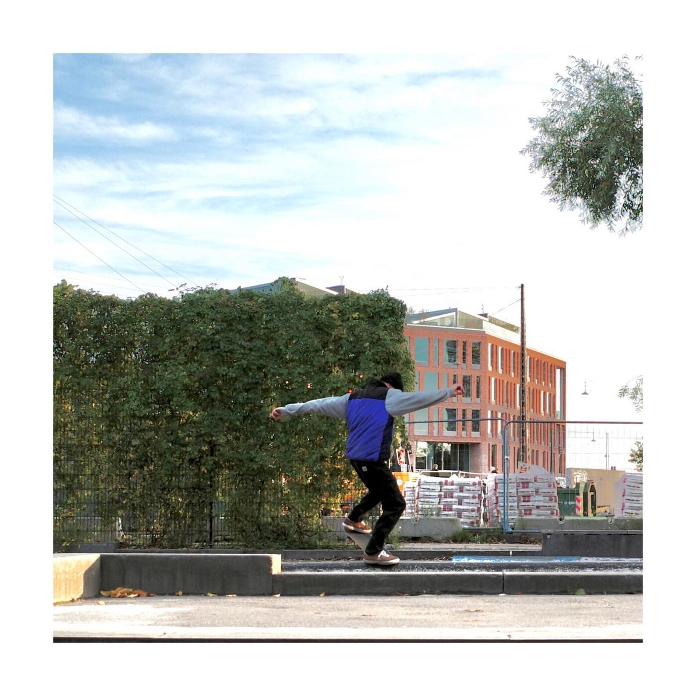 Skateboarder mid-air against a building