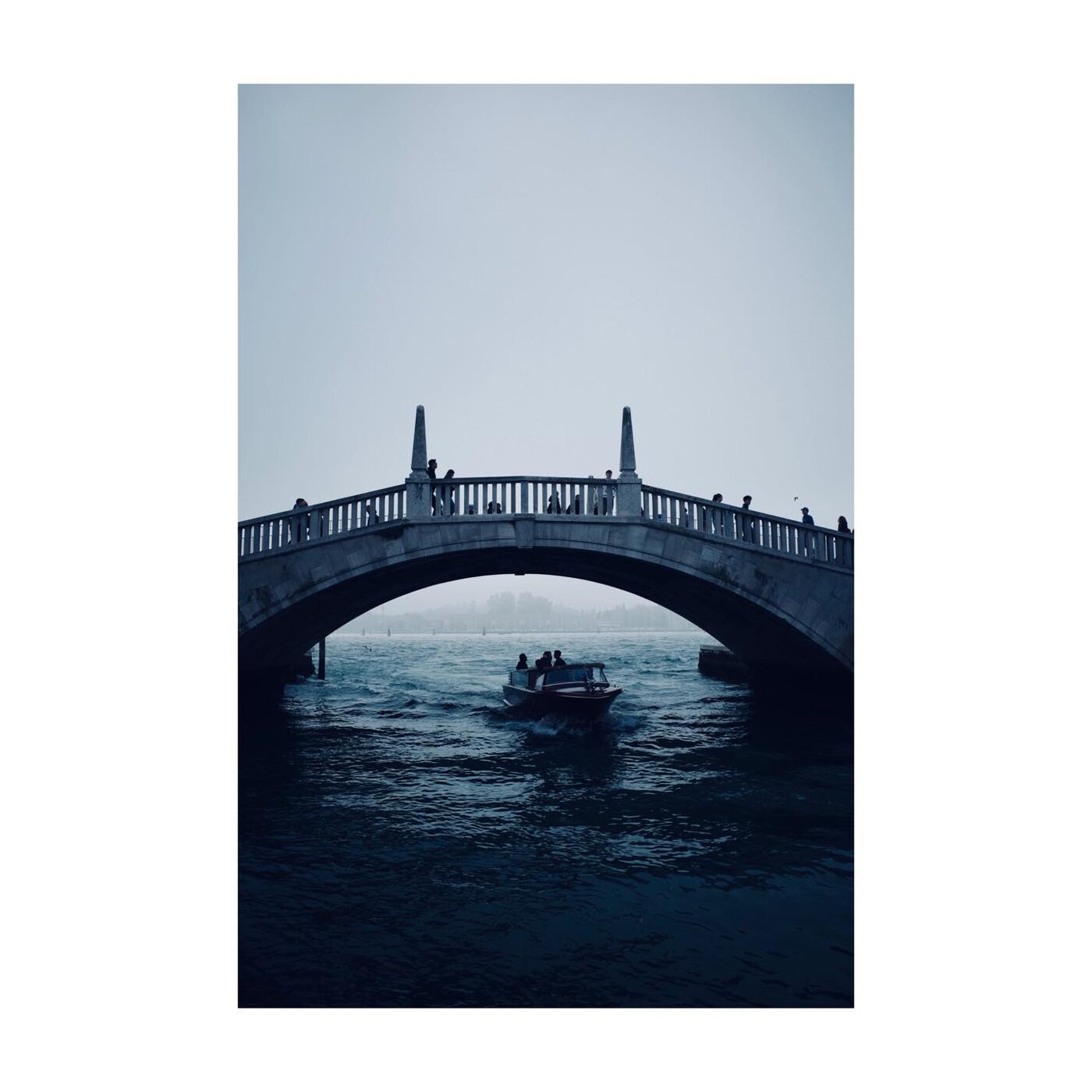 A stone bridge over a quiet canal
