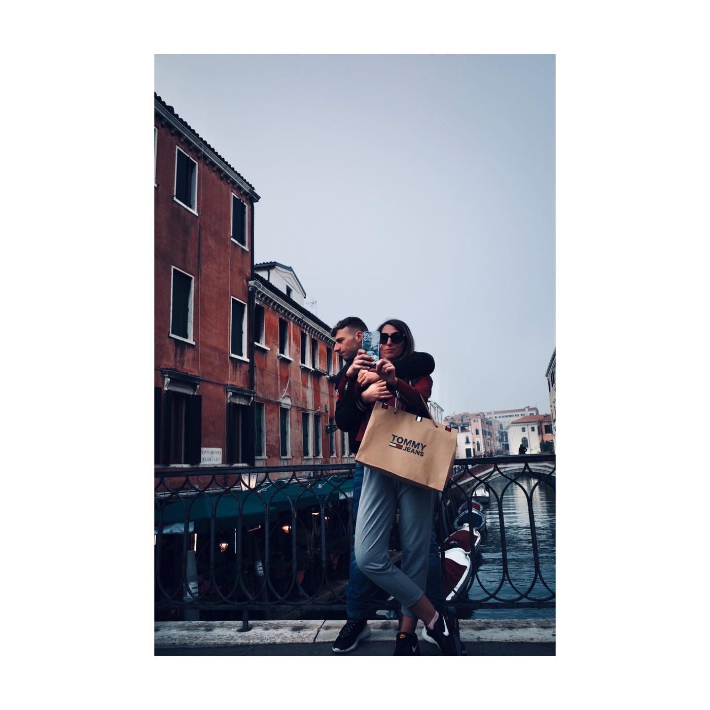 A couple held close on a bridge in Venice